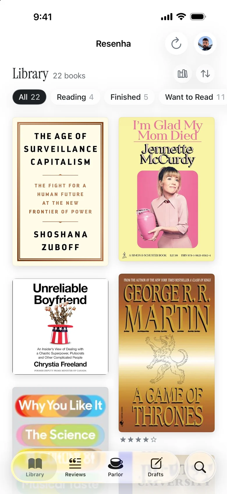 Resenha on iPhone, showing a library of book covers.